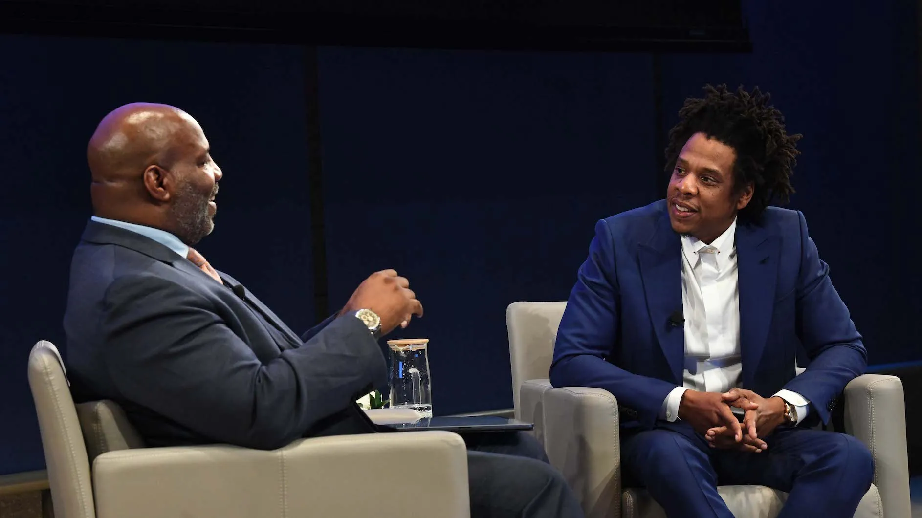 Two men seated in conversation