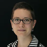 Headshot of a light-skinned women with short dark hair and glasses