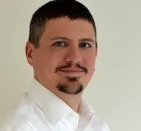 Richard Nephew with closely cropped brown hair and moustache and goatee