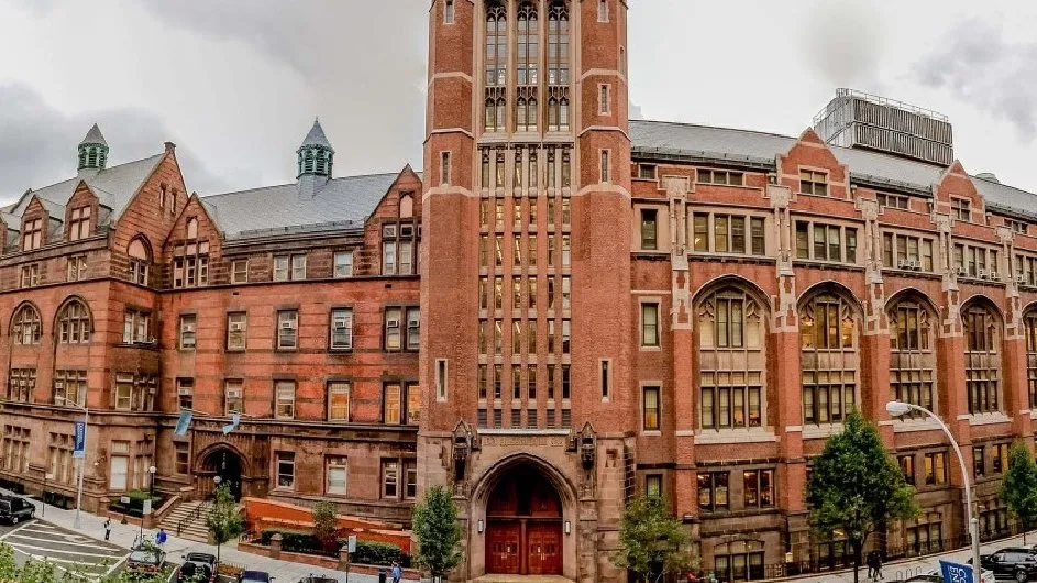 Teachers College, a Gothic style building with a red front double doors.