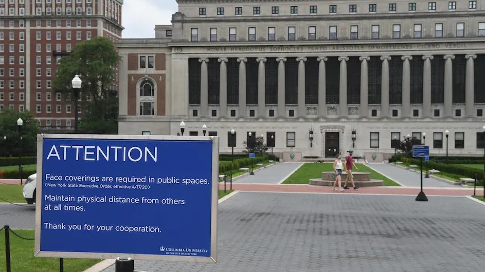 Signage on Columbia's campus near Butler Library stating that people need to wear face masks.