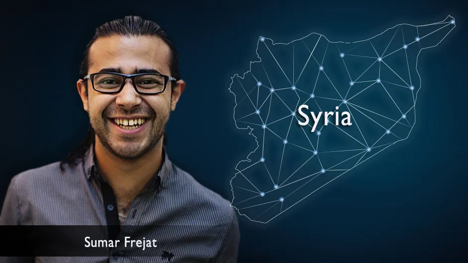 A man with dark hair and glasses next to an astral image of Syria.
