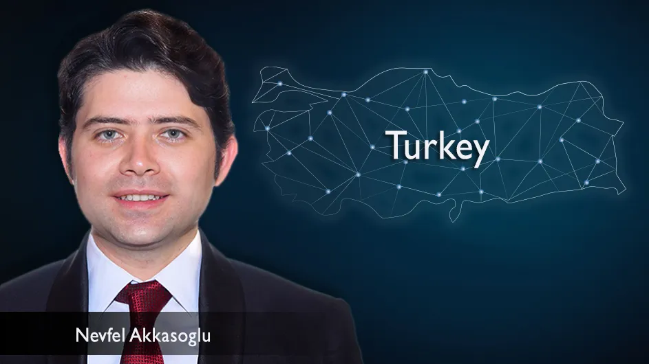 Man with short, dark hair in a suit and tie, against the backdrop of a dark blue astral map of Turkey. 