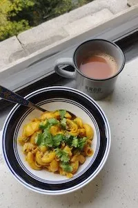 An image of a bowl of pasta and a cup of coffee