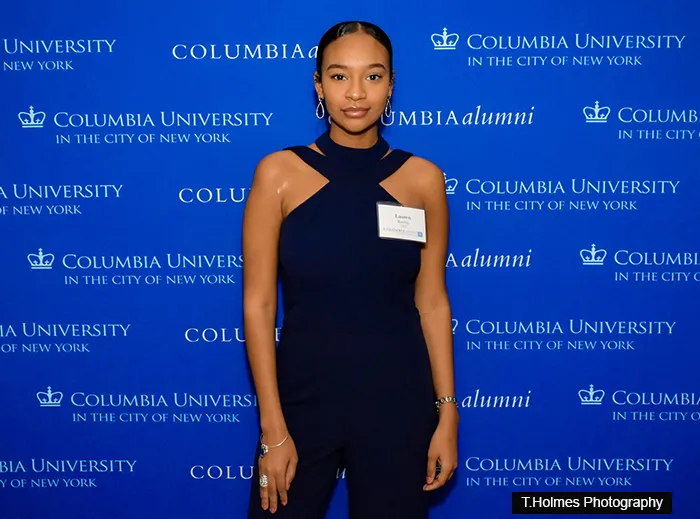Lauren Ritchie in front of a Columbia Alumni step-and-repeat.