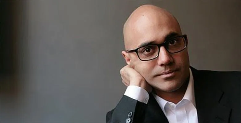 Ayad Ahktar close-up photo with a gray background