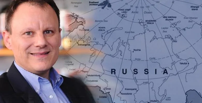 Timothy Frye in front of a map of Russia