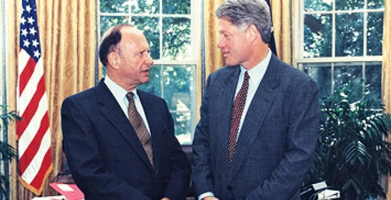 President Clinton looks toward a man in the oval office