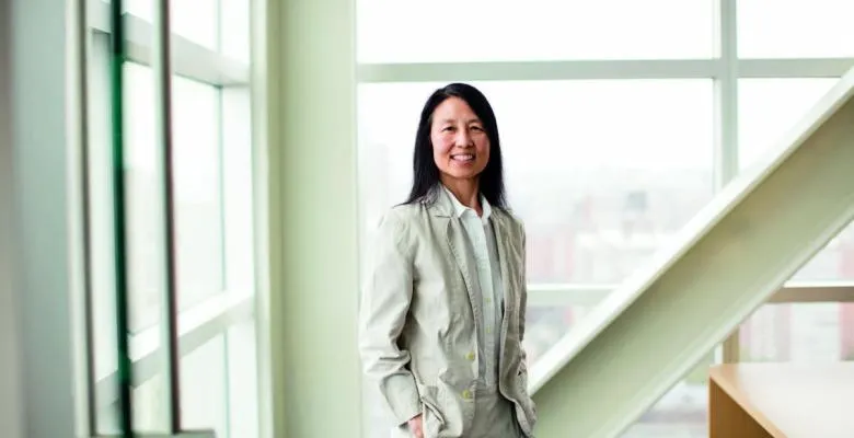 Jeannette Wing in a beige suit, in a white, well-lit room