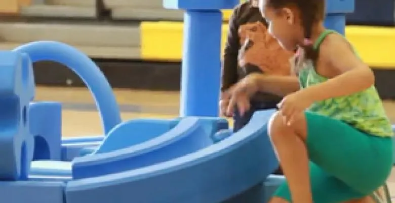 A child plays with blue foam blocks