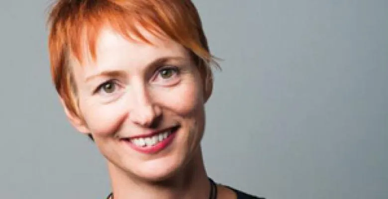 Smiling woman with short cropped red hair