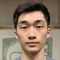 a man with brown hair looking at camera