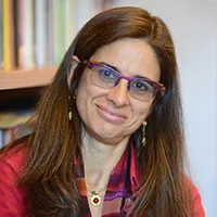 A bespectacled woman smiling