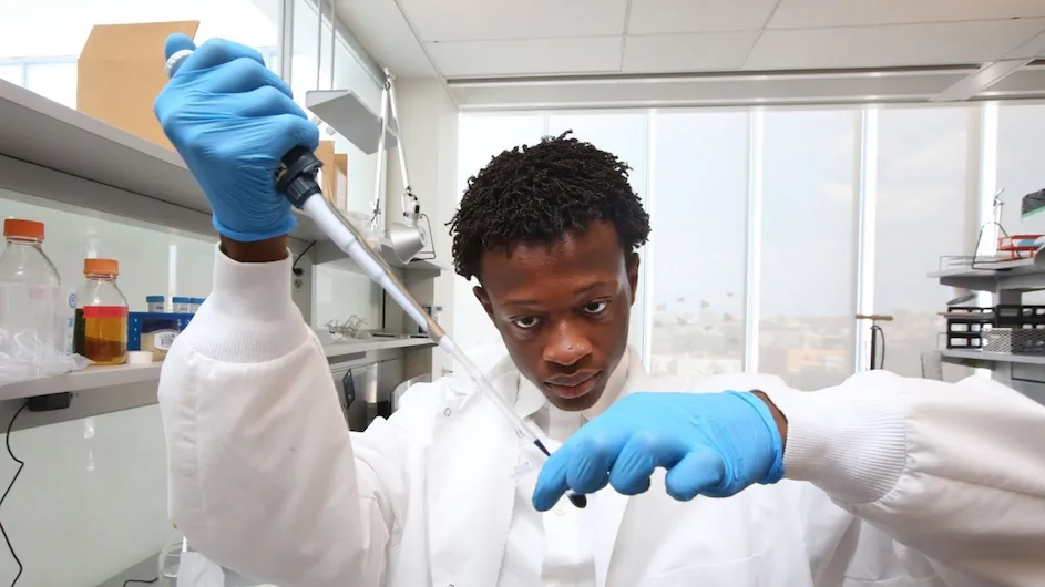 A high school student in the Zuckerman Institute's BRAINYAC program uses a pipette in the lab. 