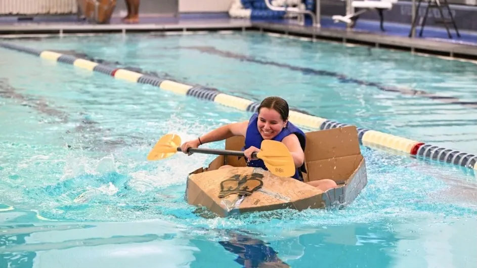 A student competes in the annual cardboard boat competition held Sept. 26 in Uris Pool