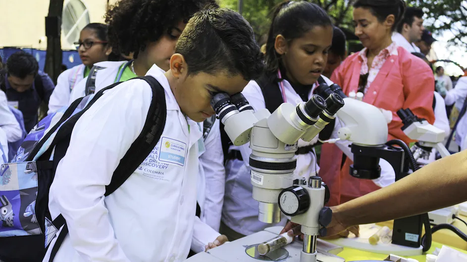 A visitor looks at a microscope at Columbia University Irving Medical Center's Curiosity Minds Science Zone. 