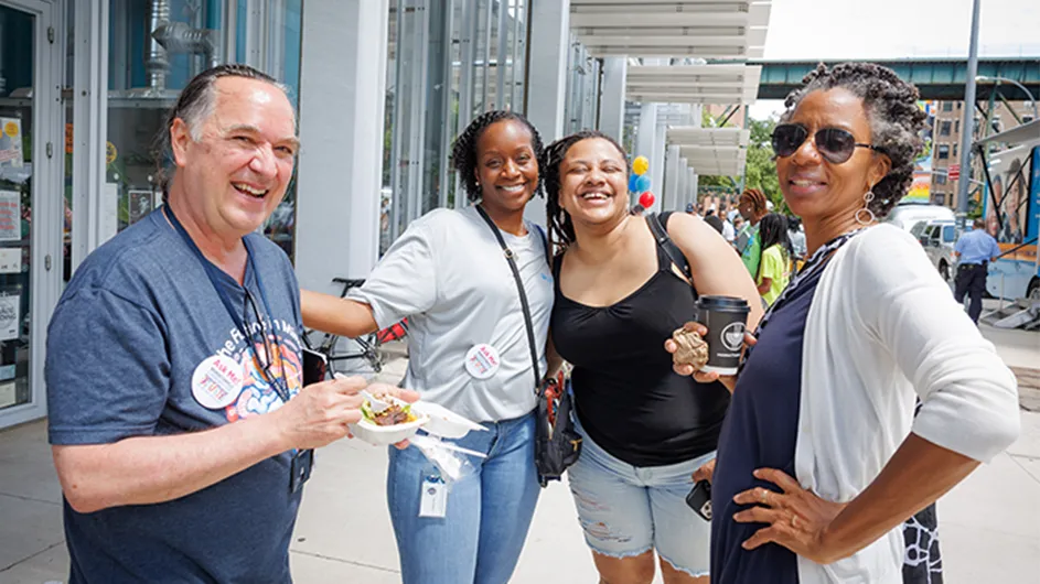 volunteers and visitors gather for community day