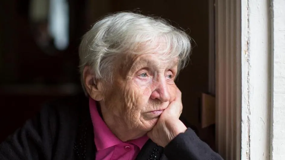 An older person looking forlorn.