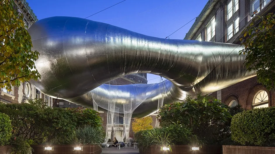 A large silver-colored inflatable sculpture named cloud as an art installation on the plaza by Avery, Fayerweather, and Schermerhorn halls at Columbia University. 