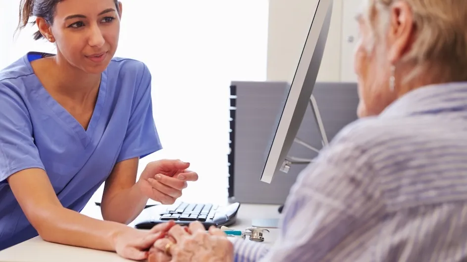 A doctor speaks with an older patient.