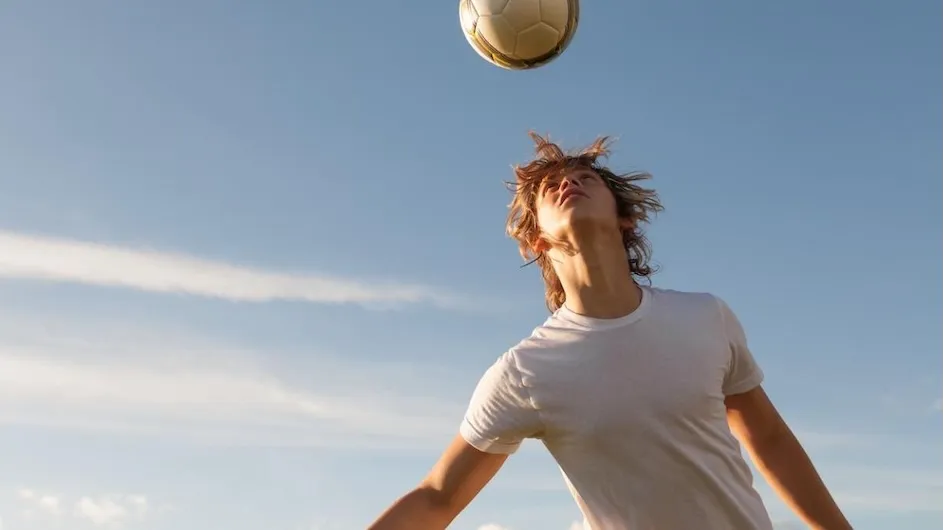 A person heading a soccer ball.