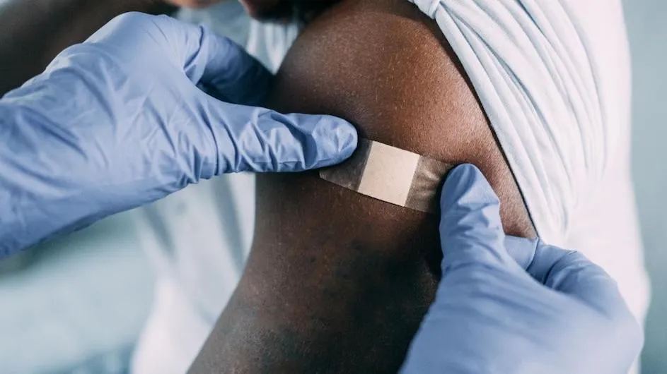 Image of a band-aid on a patient's shoulder.